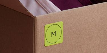 Green mini square sticker with size on mailing box