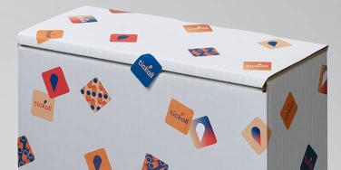 White box covered in mini square stickers in various designs