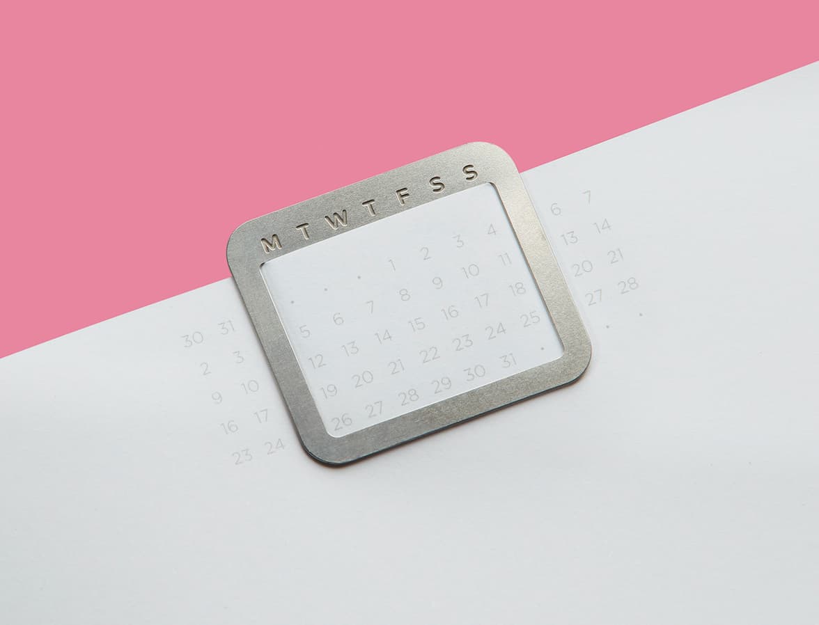 A close up image of the inside of a perpetual planner with a silver calendar clip.