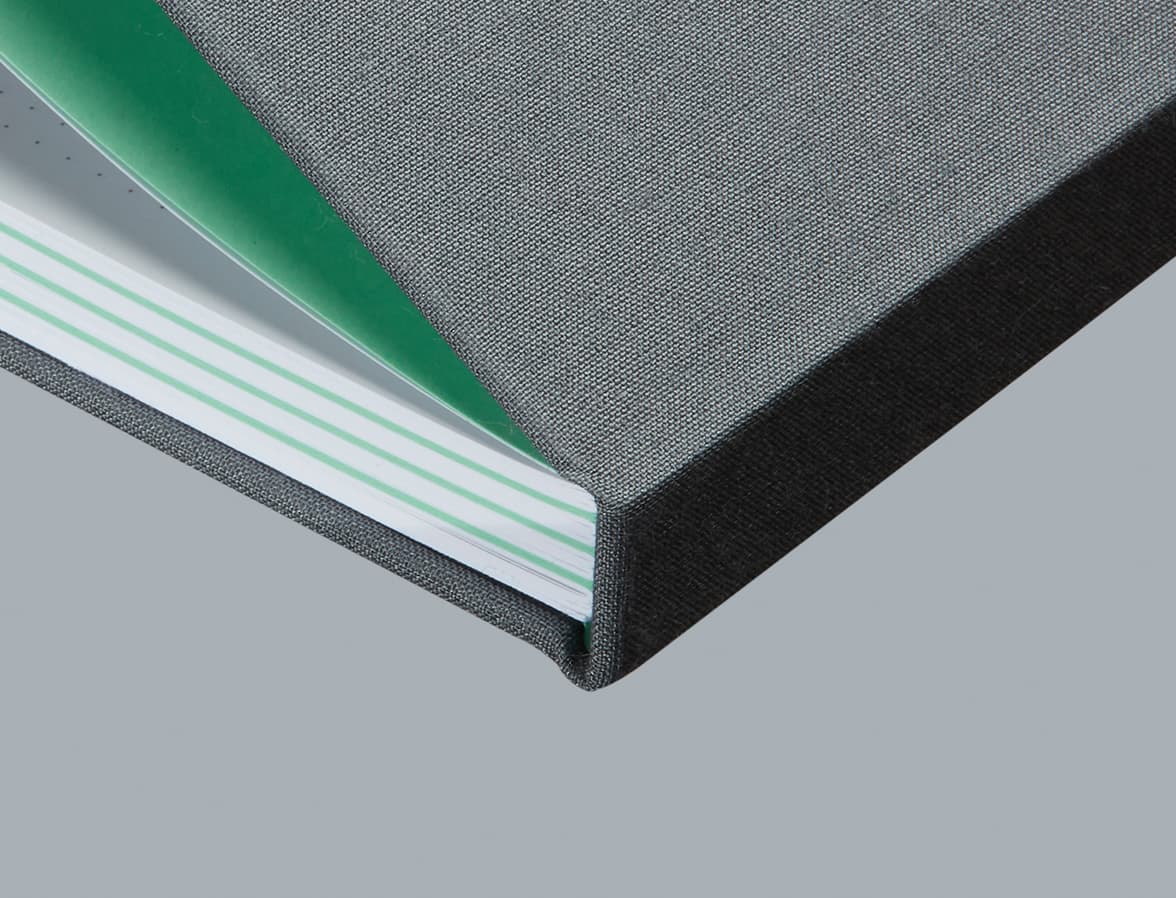 A close up image of a grey MOO perpetual planner, focusing on the spine and pages.