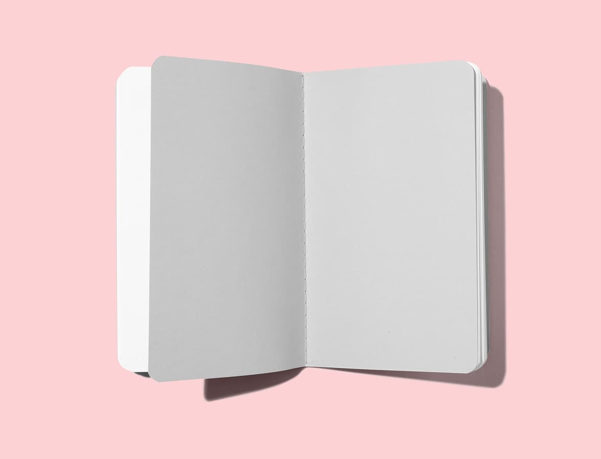 An open softcover planners, showing plain grey pages.