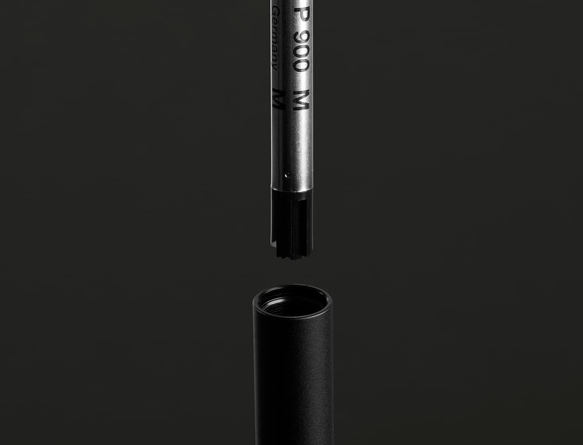 A deconstructed jet black MOO twist pen.