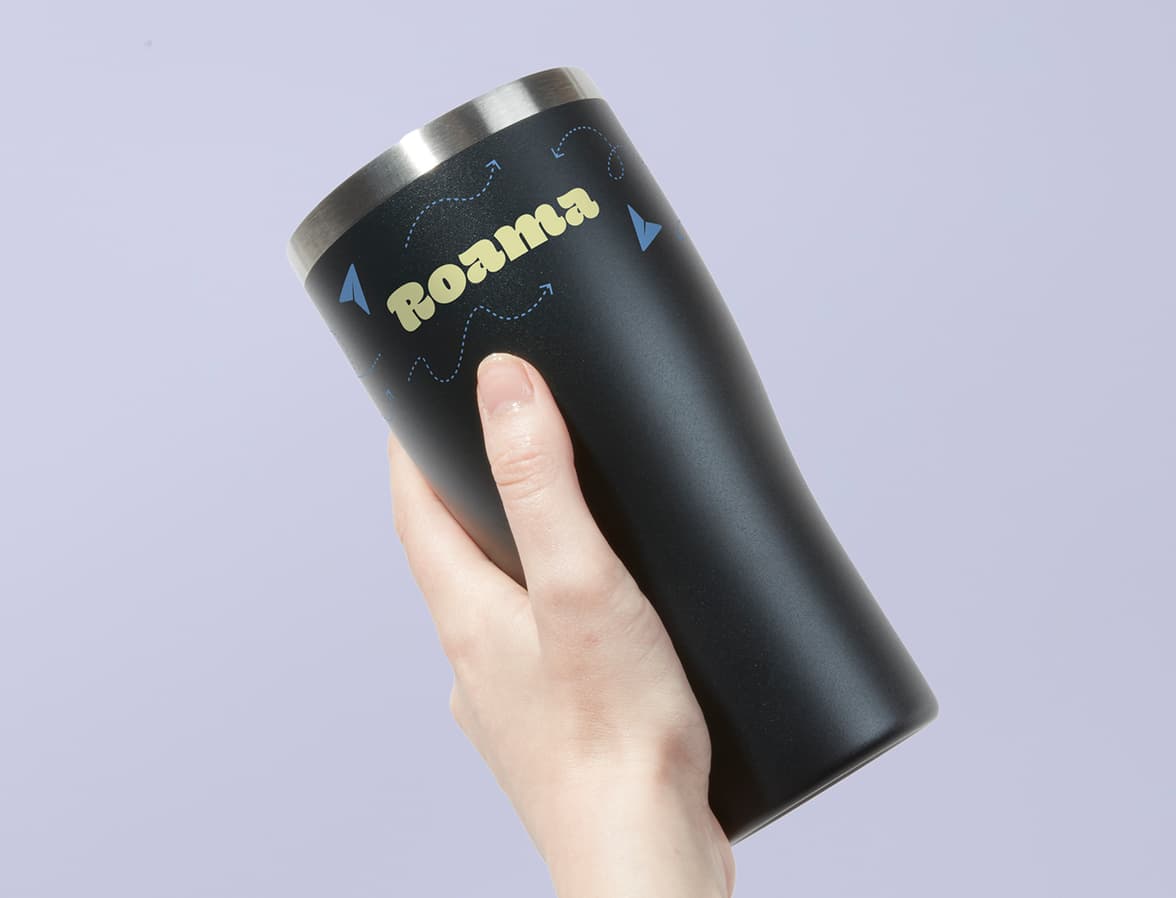 One hand holding the Insulated Tumbler in Jet Black with 360 wrap printing customisation