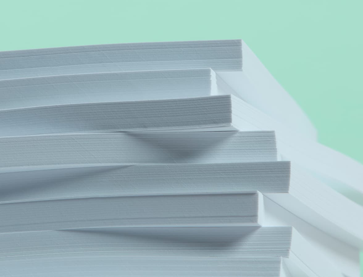 A collection of notepads stacked on top of each other.