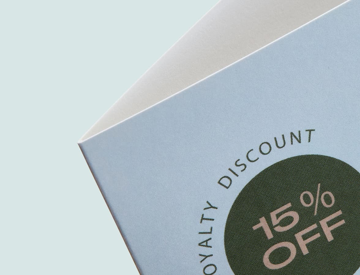 Detail image of the top corner of a half open bi-fold brochure.