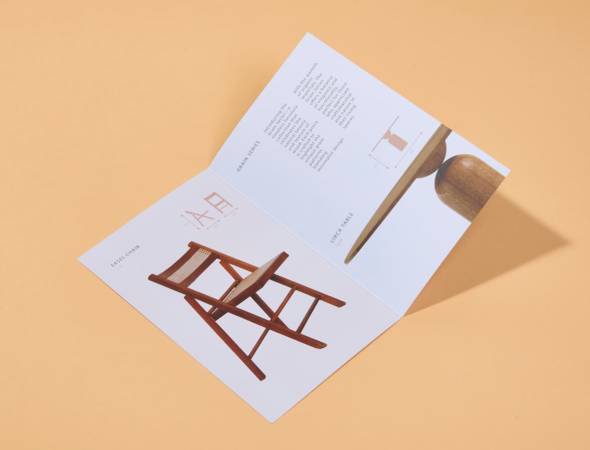 A bi-fold brochure laid on an orange background.