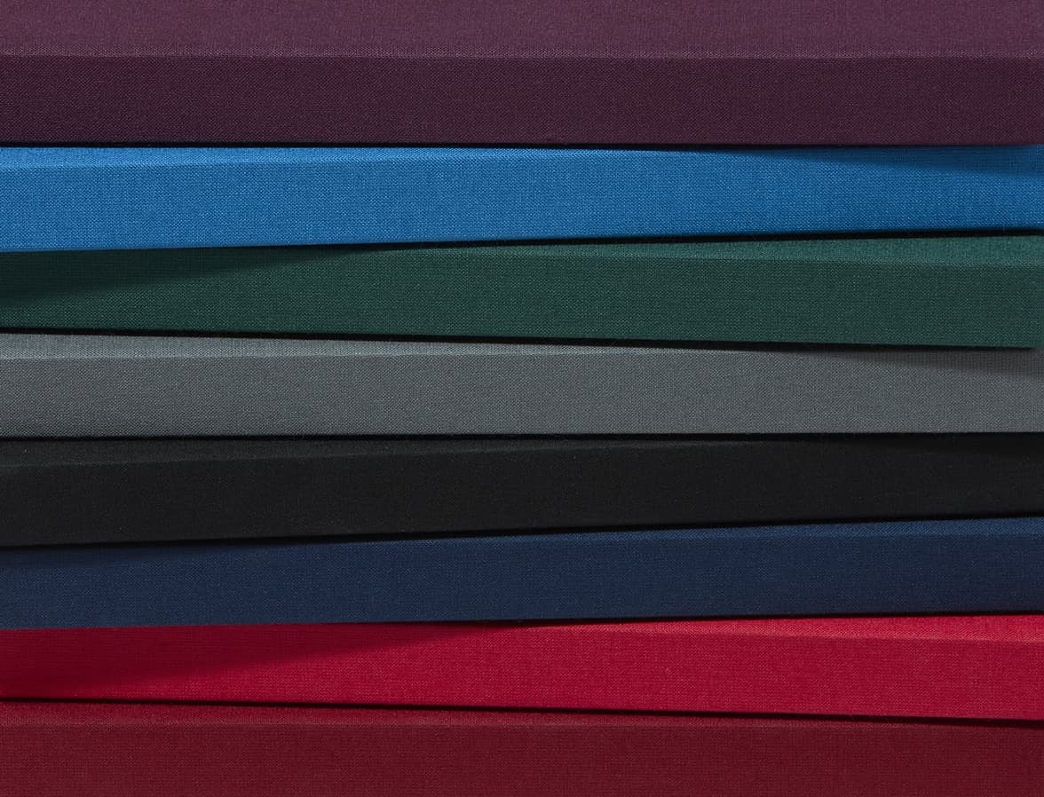 A collection of hardcover notebooks stacked on top of each other focusing on the spine.