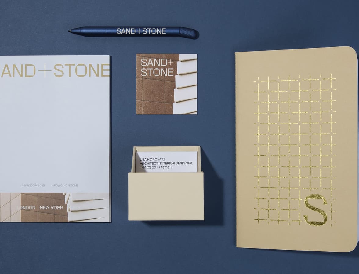 A collection of customised print products including the boxed luxe business cards, notebook and a midnight blue pen.