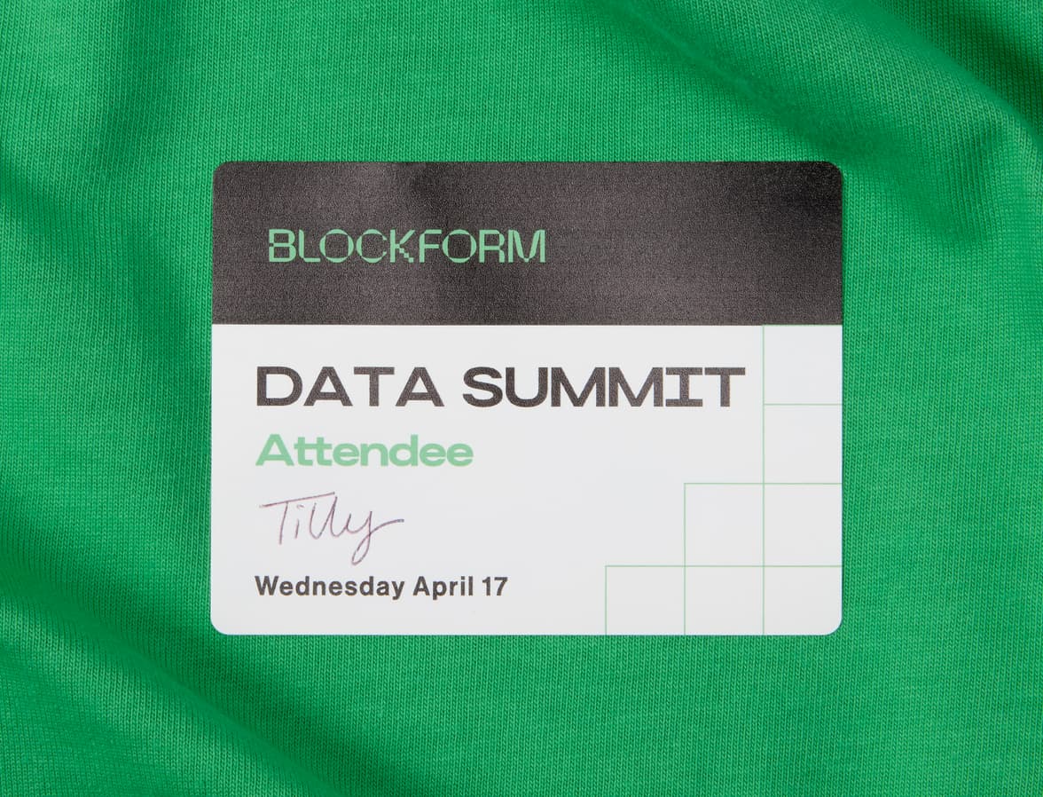 A close up image of a customized coated rectangular sticker placed on clothing.