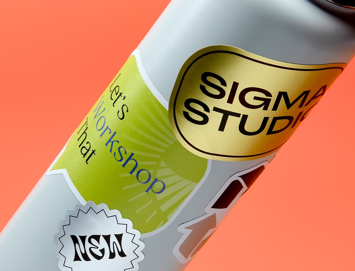 A close up image of a variety of different stickers placed onto a water bottle.