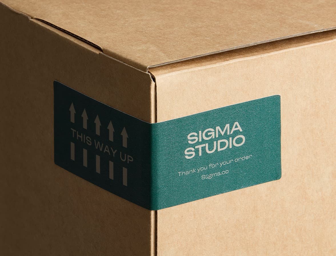 A customized matte paper sticker placed on the corner of a cardboard box.