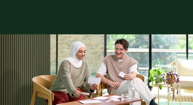 A couple looking at paper print products