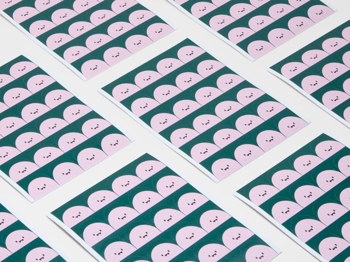 A collection of round coated paper labels with animated faces printed on it.