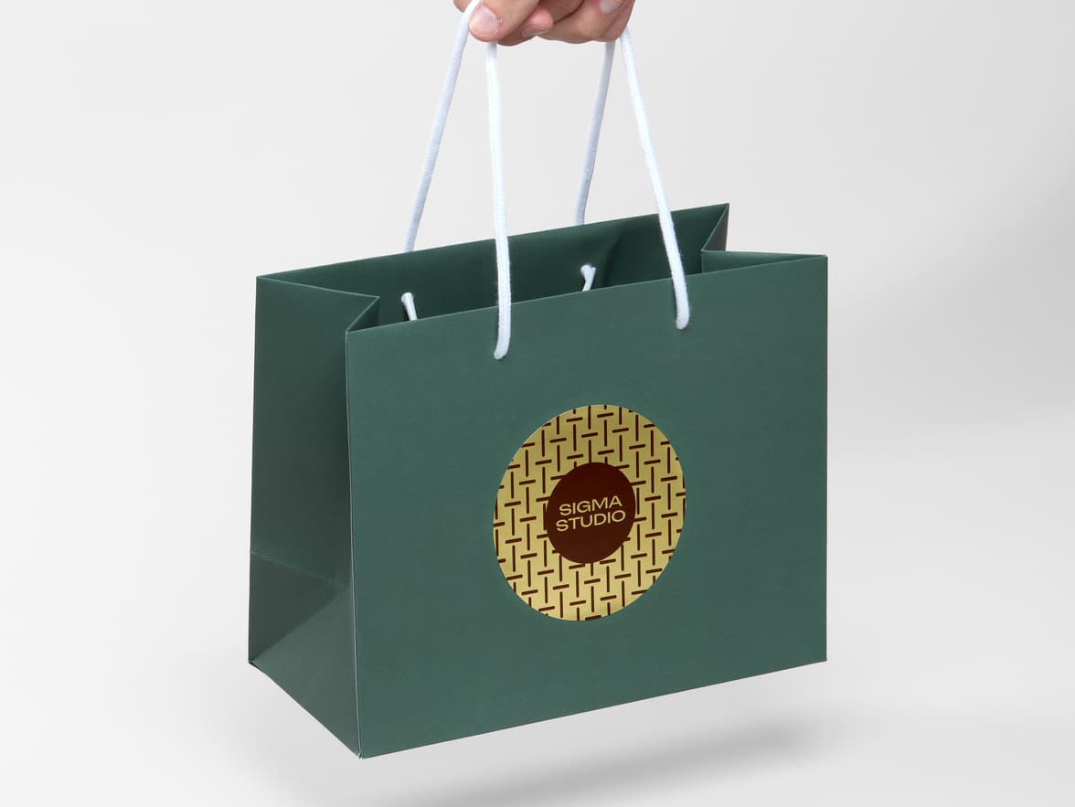 A bag with a large round gold metallic sticker placed on it.