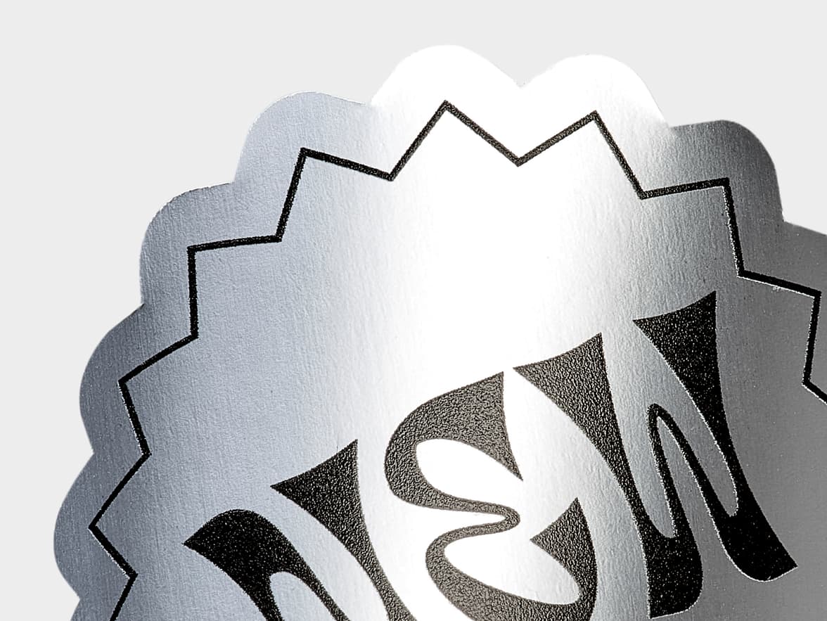 A close up image of a customized silver metallic sticker.