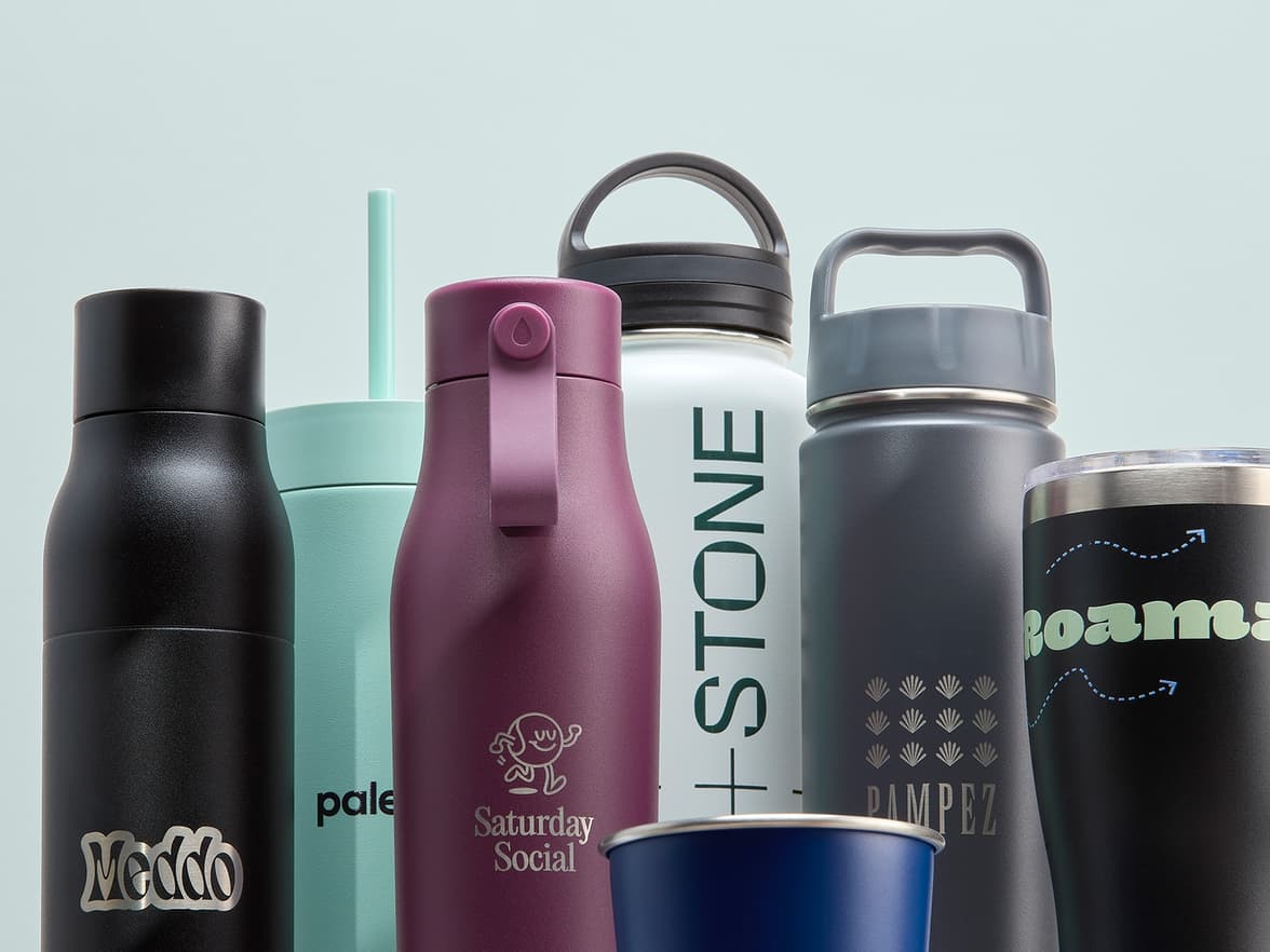 A collection of customized drinkware with a mint green background.