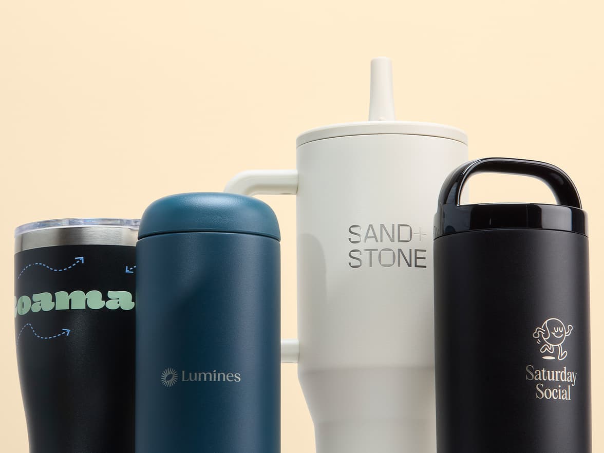 A collection of customized tumblers in front of a pale yellow background.