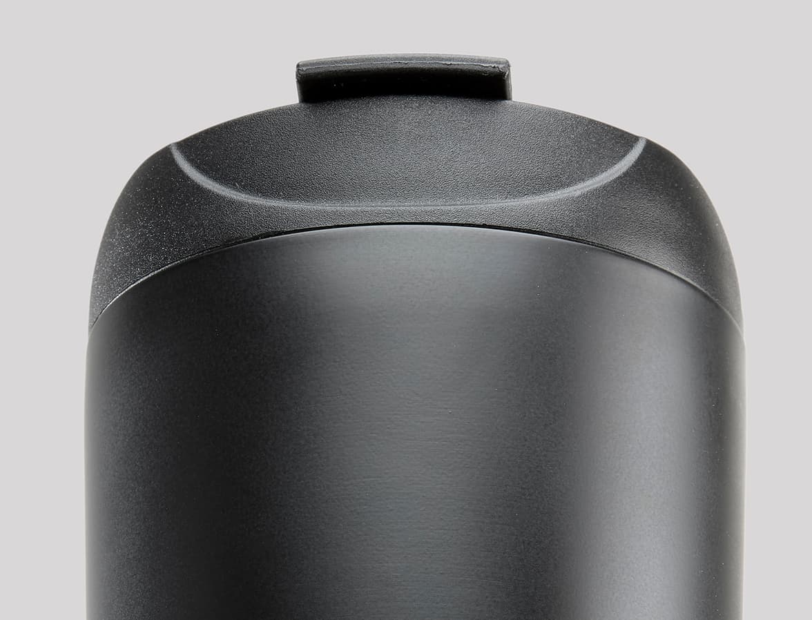A close up of the top of a black water bottle.