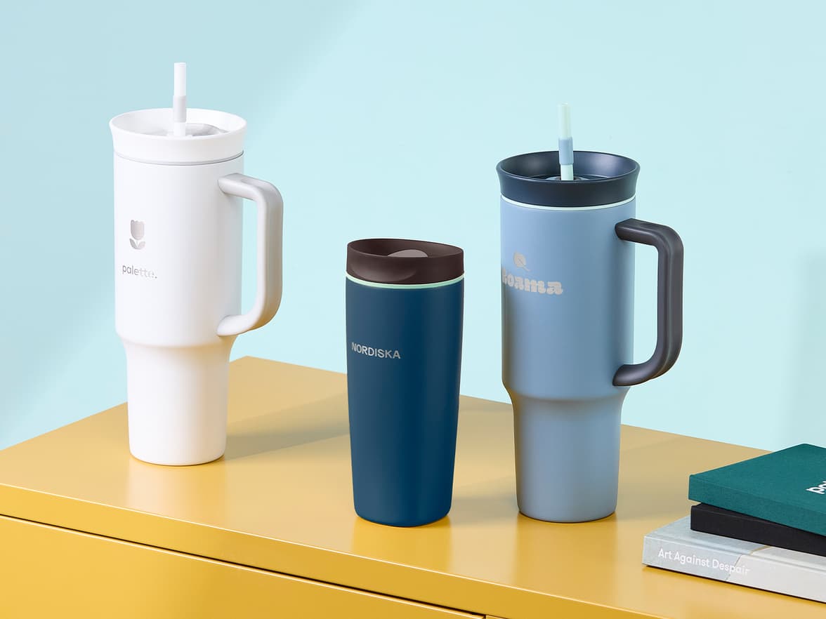 A collection of customized tumblers placed on a yellow table.