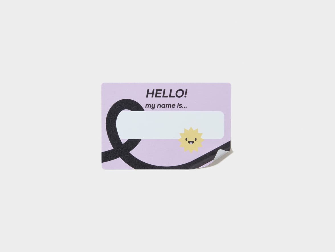 A lilac colored customized rectangular name tag.