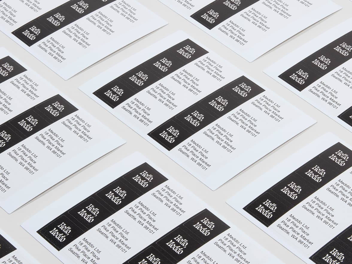 A collection of rectangular white and black return address labels.