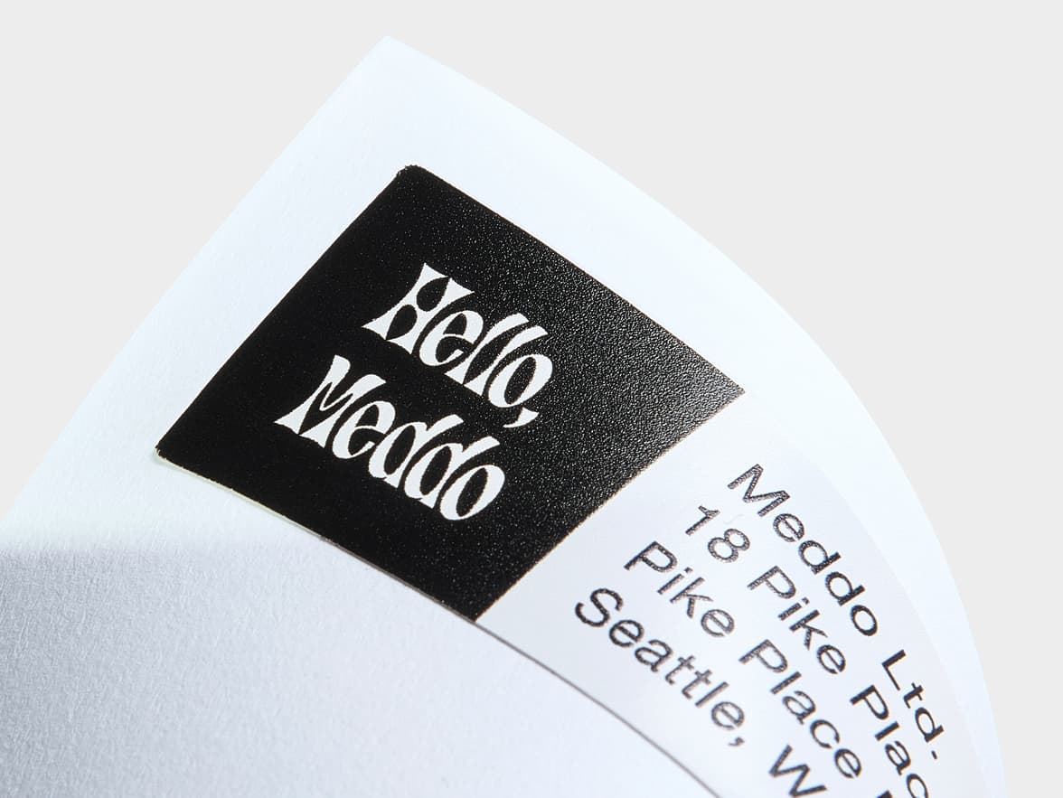 A close up image of the right side of a rectangular white and black return address label.