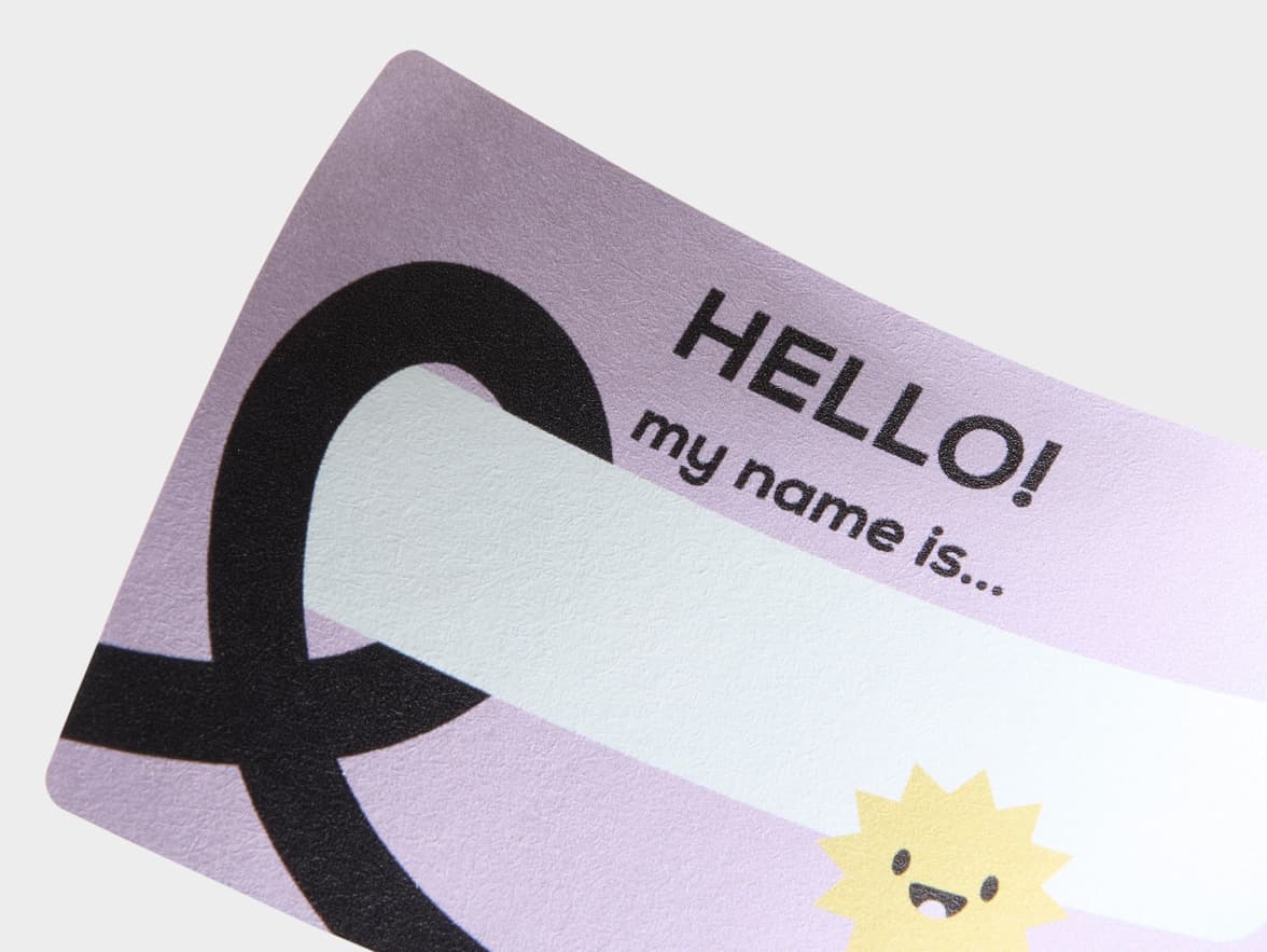 A close up image of a customized lilac rectangular name tag.