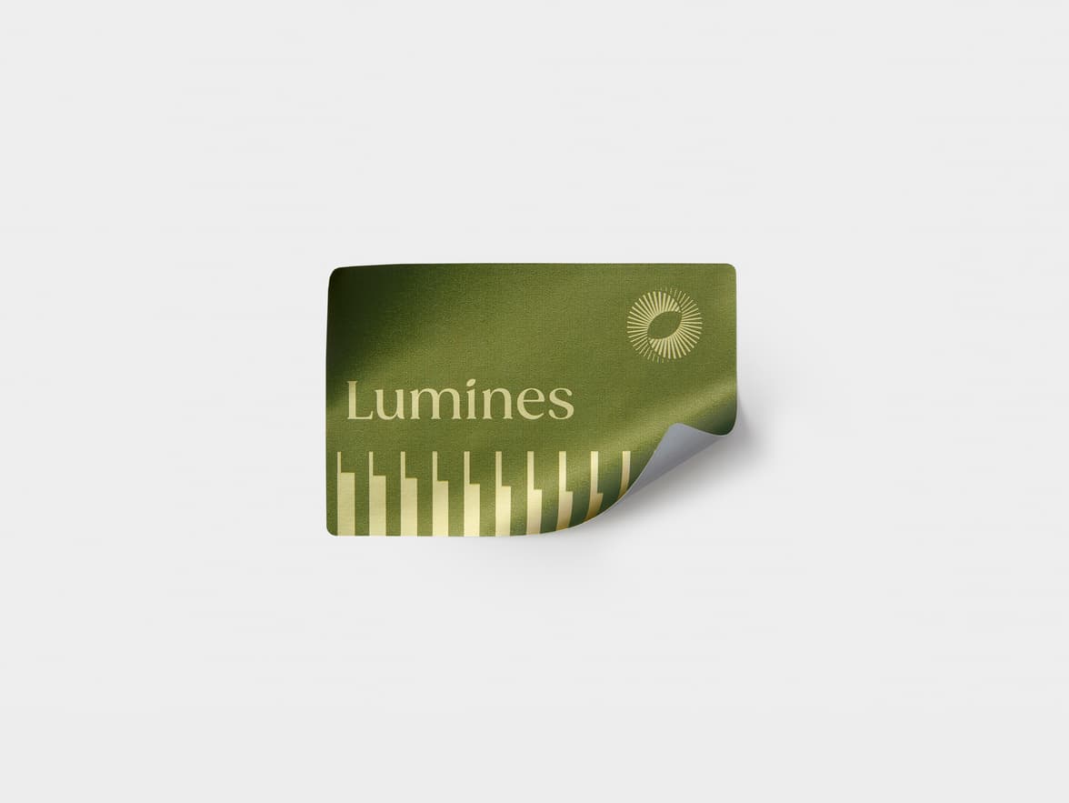 A rectangular gold metallic sticker with green customization.