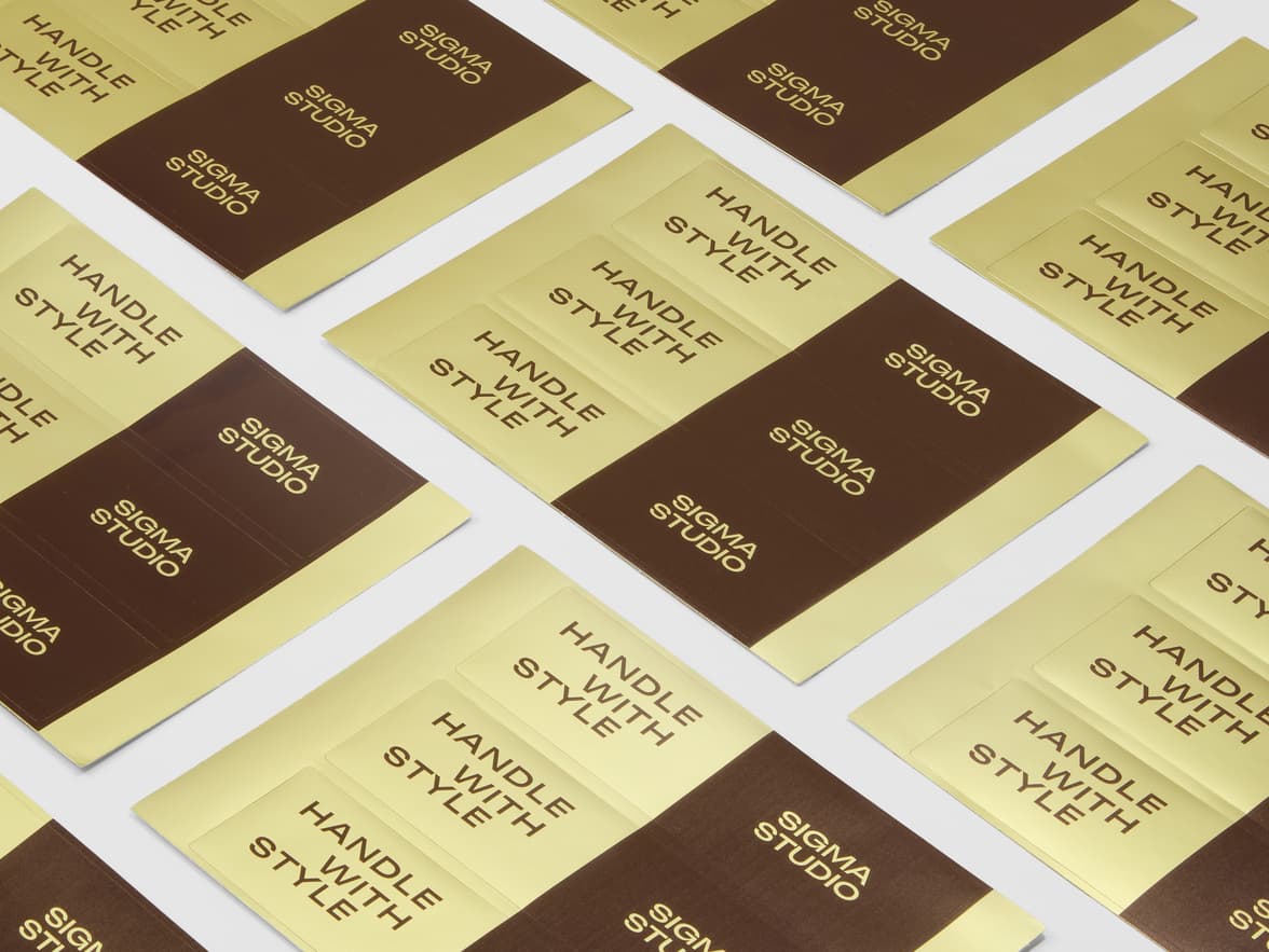 A collection of gold and brown metallic customized stickers on sheets.