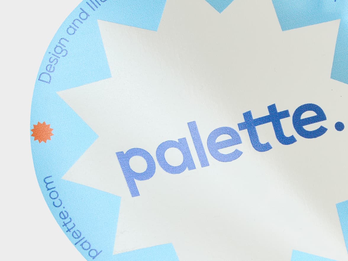 A close up image of a customized round clear sticker with the word 'palette' printed on it.