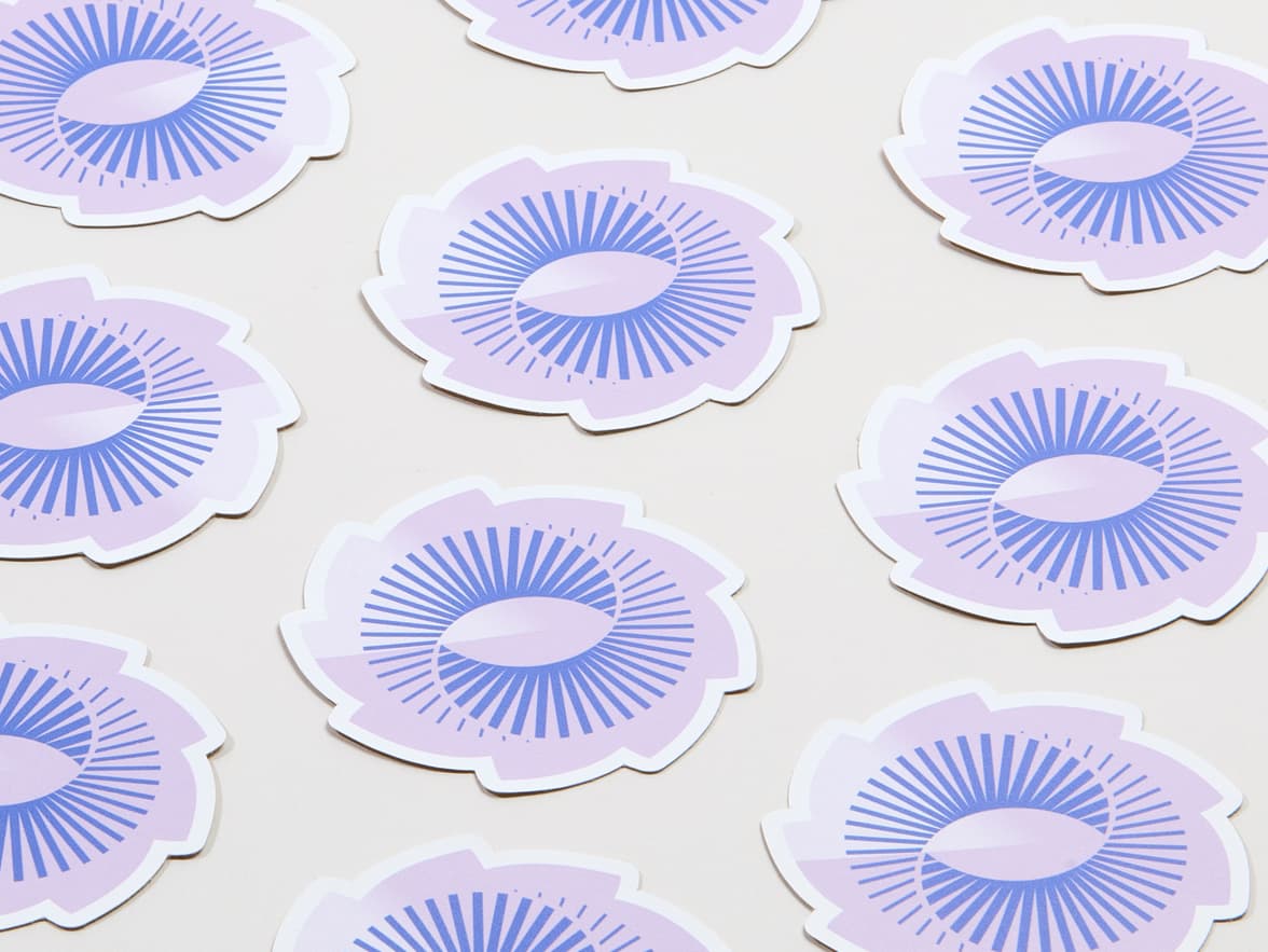 A collection of matte paper stickers with the design and shape of a spiral.