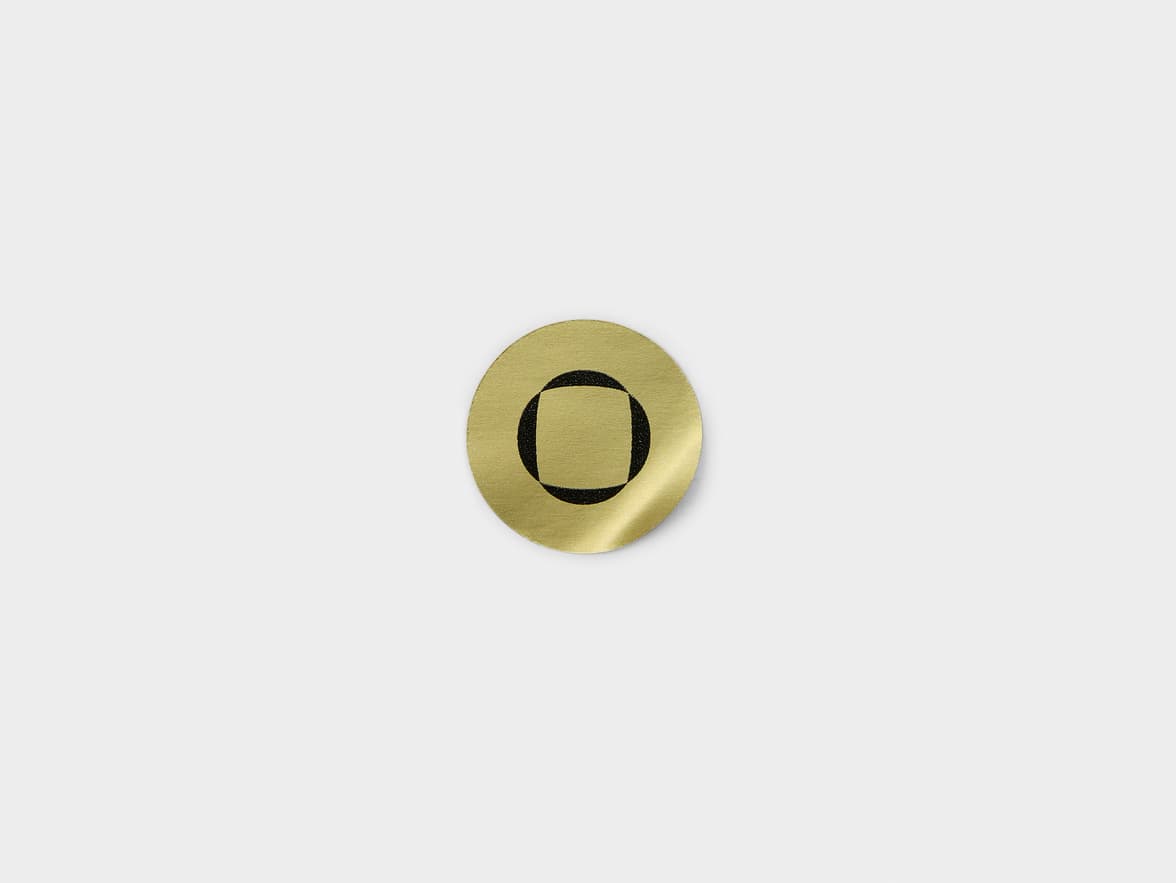 A round gold metallic sticker with customization.