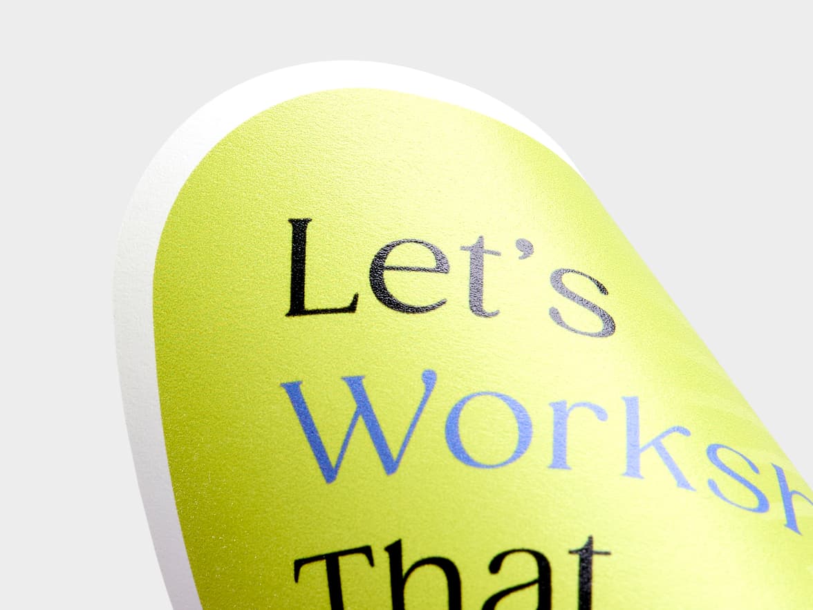 A close up image of a customized matte paper sticker in the shape of a speech bubble.