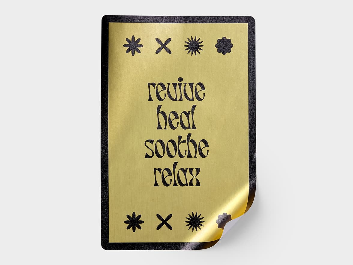 A custom gold foil sticker with black customization.