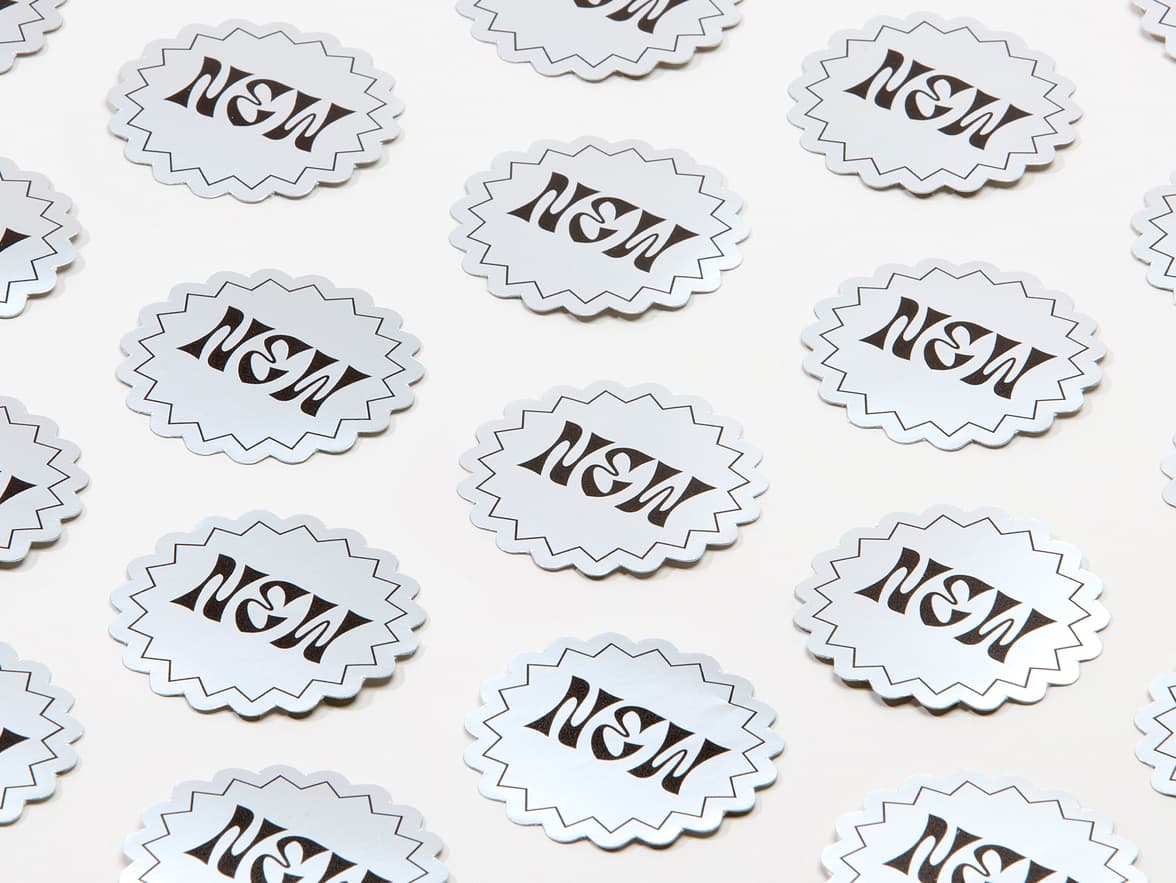 A collection of customized starburst shaped silver metallic stickers.
