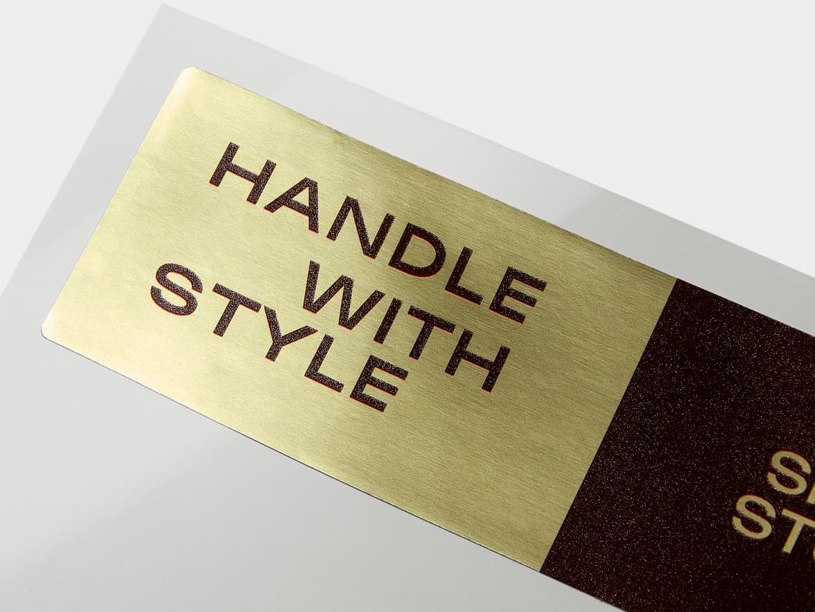 A close up image of a gold and brown metallic customized sticker.