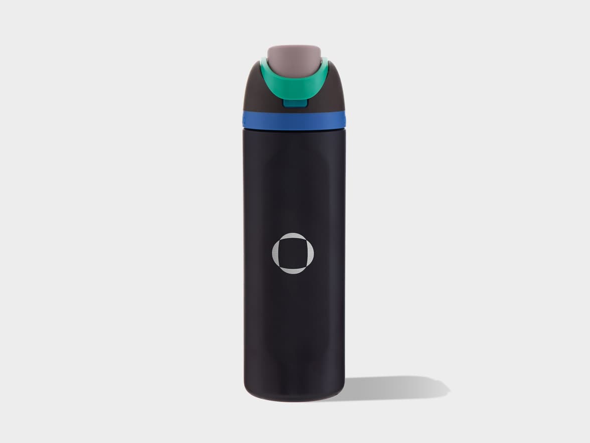 A black insulated water bottle with a grey, blue, and green cap, featuring a white circular logo with a vertical cutout in the center.