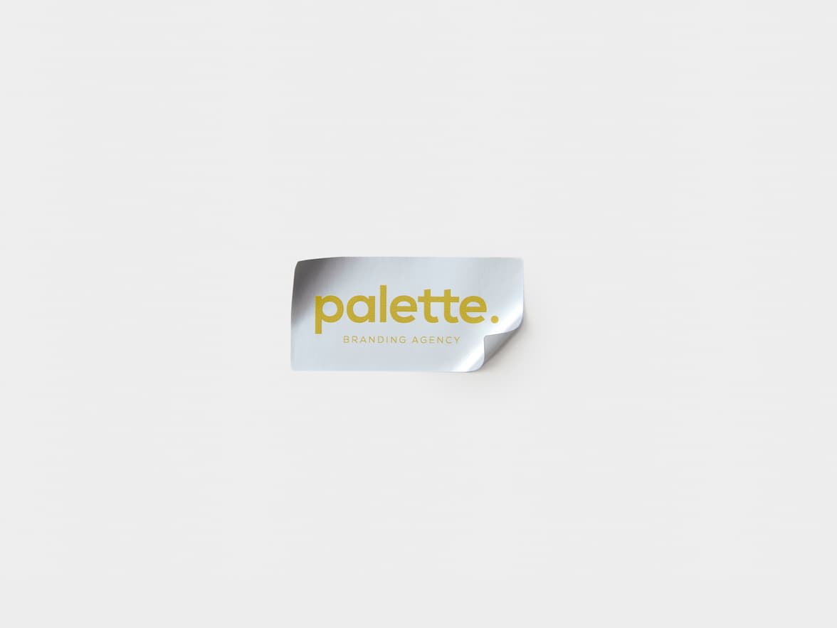 A silver rectangular sticker with yellow customization.