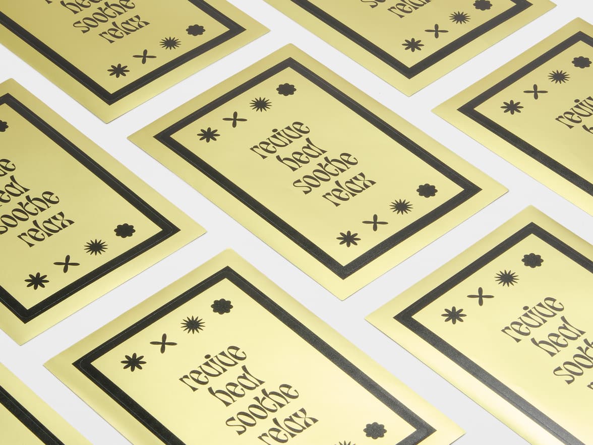 A collection of large gold metallic stickers with black customization.