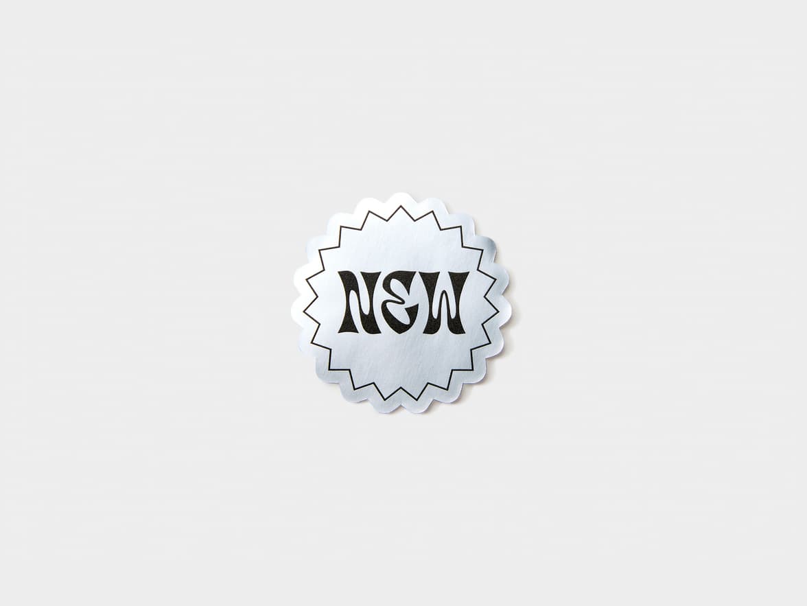 A customized silver metallic sticker in a starburst shape.