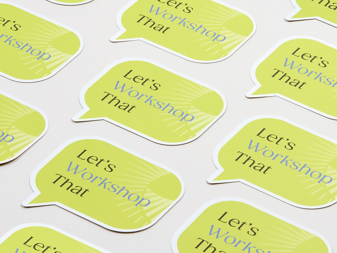 A collection of customized matte paper stickers in the shape of a speech bubble.