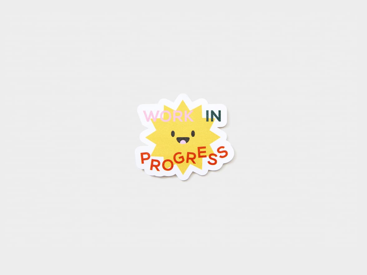 A customized matte paper sticker in the shape of a star with writing over it.