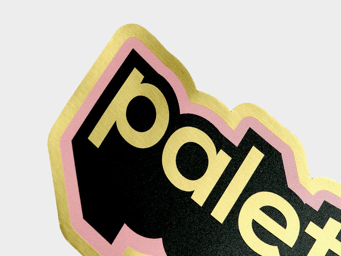 A close up image of a customized gold metallic sticker of the word 'palette'.