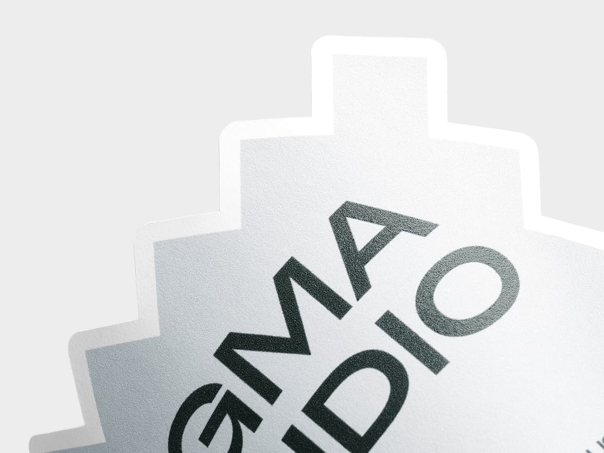 A close up of the corner of a customized matte paper sticker of a square with jagged edges.