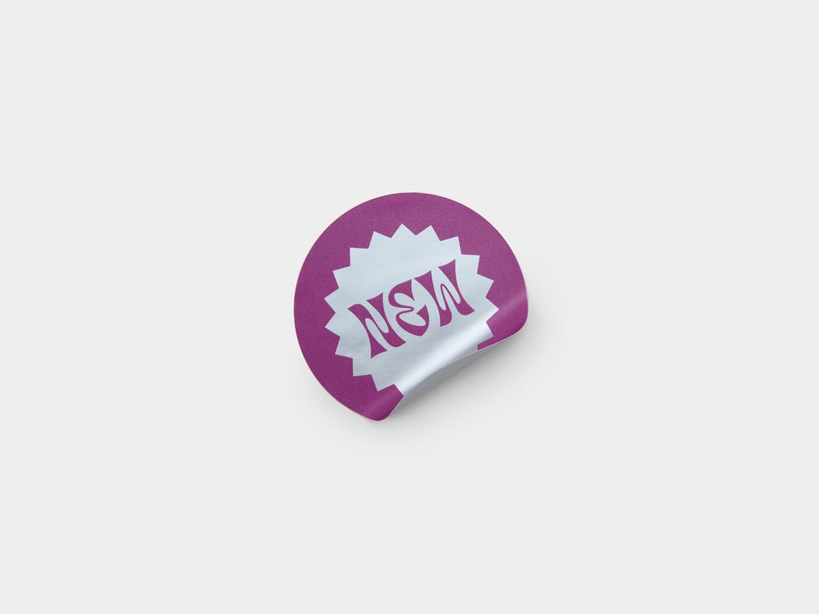 A round silver metallic sticker with purple customization.