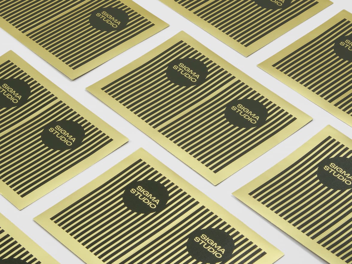 A collection of gold and black metallic rectangular stickers on sheets.